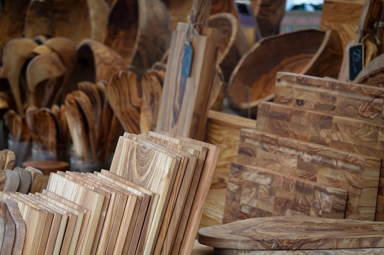 A collection of rustic kitchenware made from carved wood, ideal for home decor and culinary use.